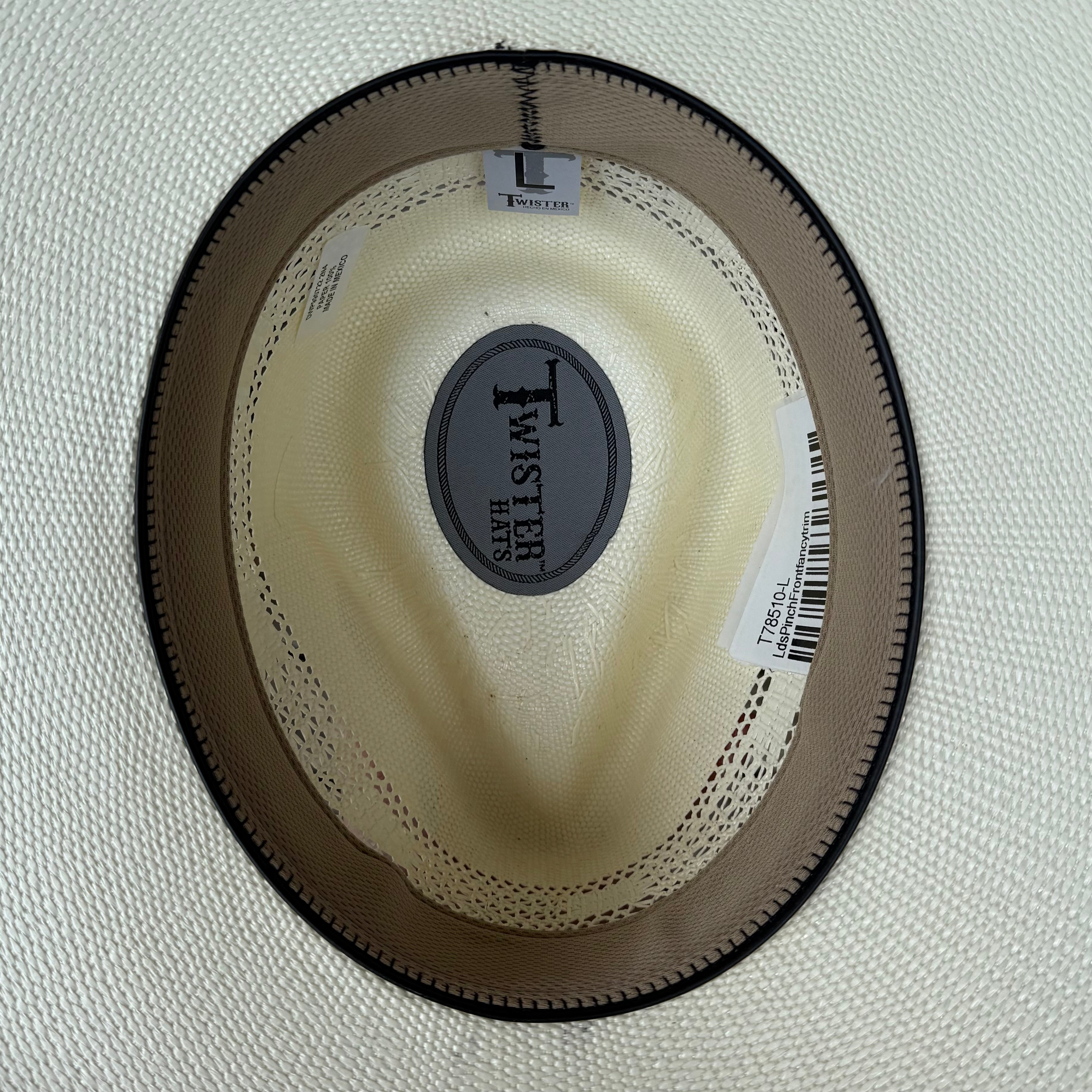 Close-up of a cowboy hat with a brand label on a white background