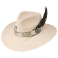 Beige cowboy hat with decorative band and feather on a white background